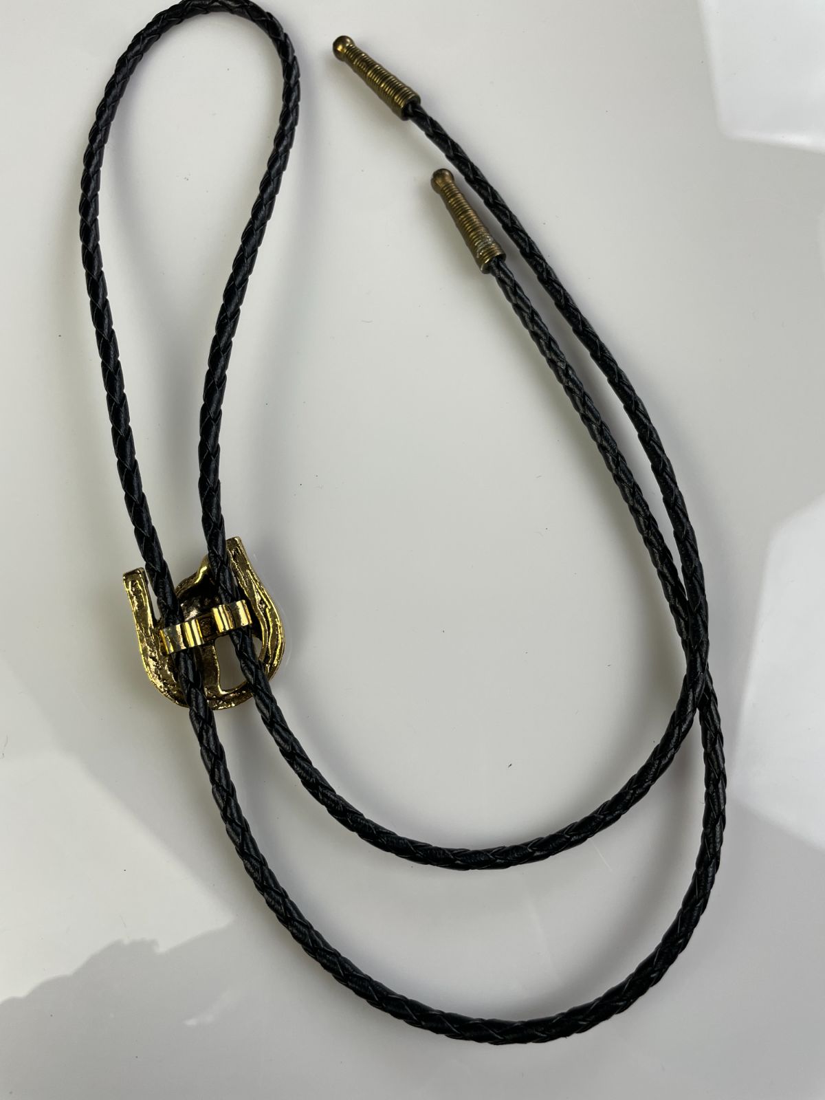 GOLD PLATED HORSE PROFILE & HORSESHOE BOLO TIE, BRAIDED LEATHER CORD in BLACK, GOLD