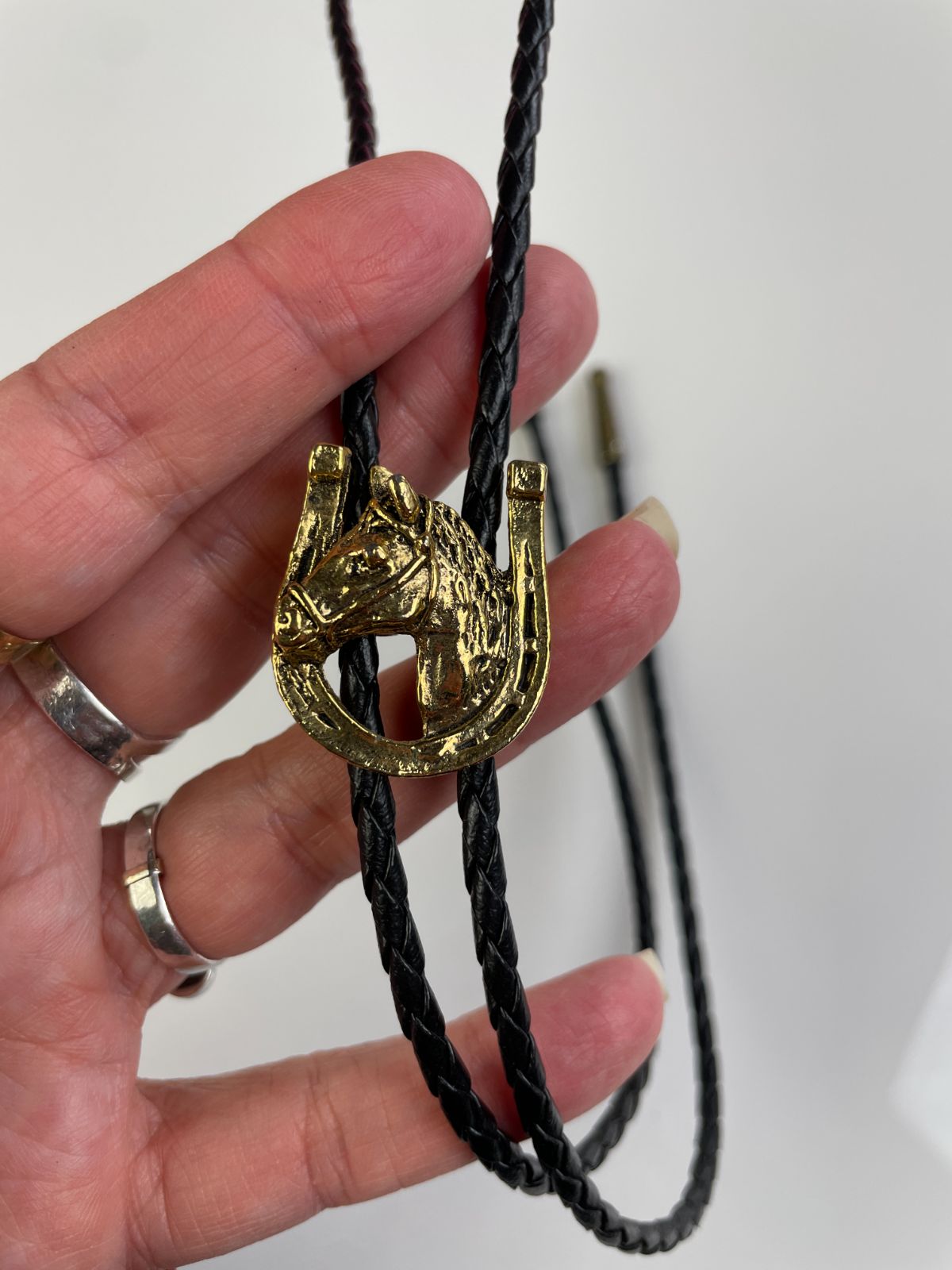 GOLD PLATED HORSE PROFILE & HORSESHOE BOLO TIE, BRAIDED LEATHER CORD in BLACK, GOLD