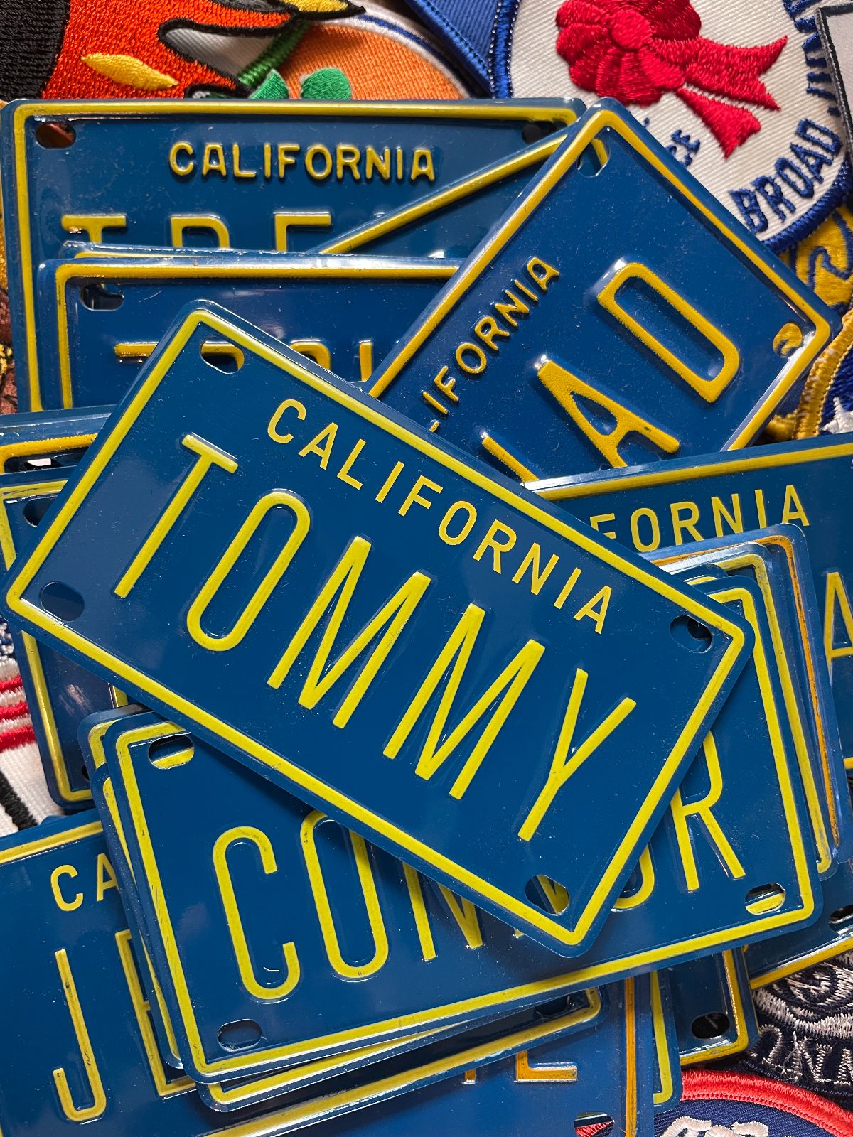 ASSORTED CALIFORNIA LICENSE PLATE NAME PLATES in BLUE, YELLOW
