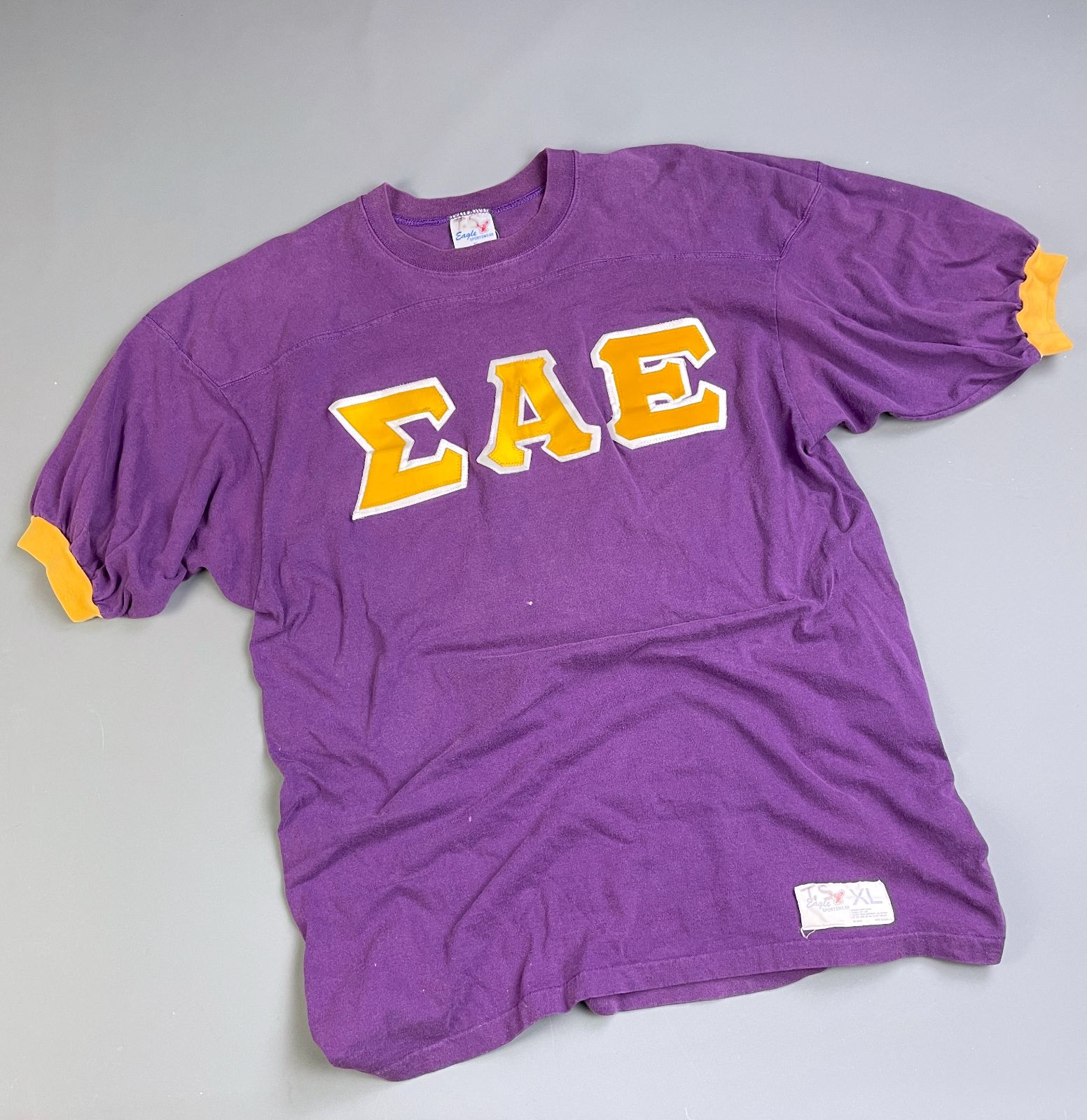 EAGLE SPORTSWEAR *AS-IS* COOL! 1970S-80S FRATERNAL LETTERING 100% COTTON RINGER TSHIRT in PURPLE, YELLOW