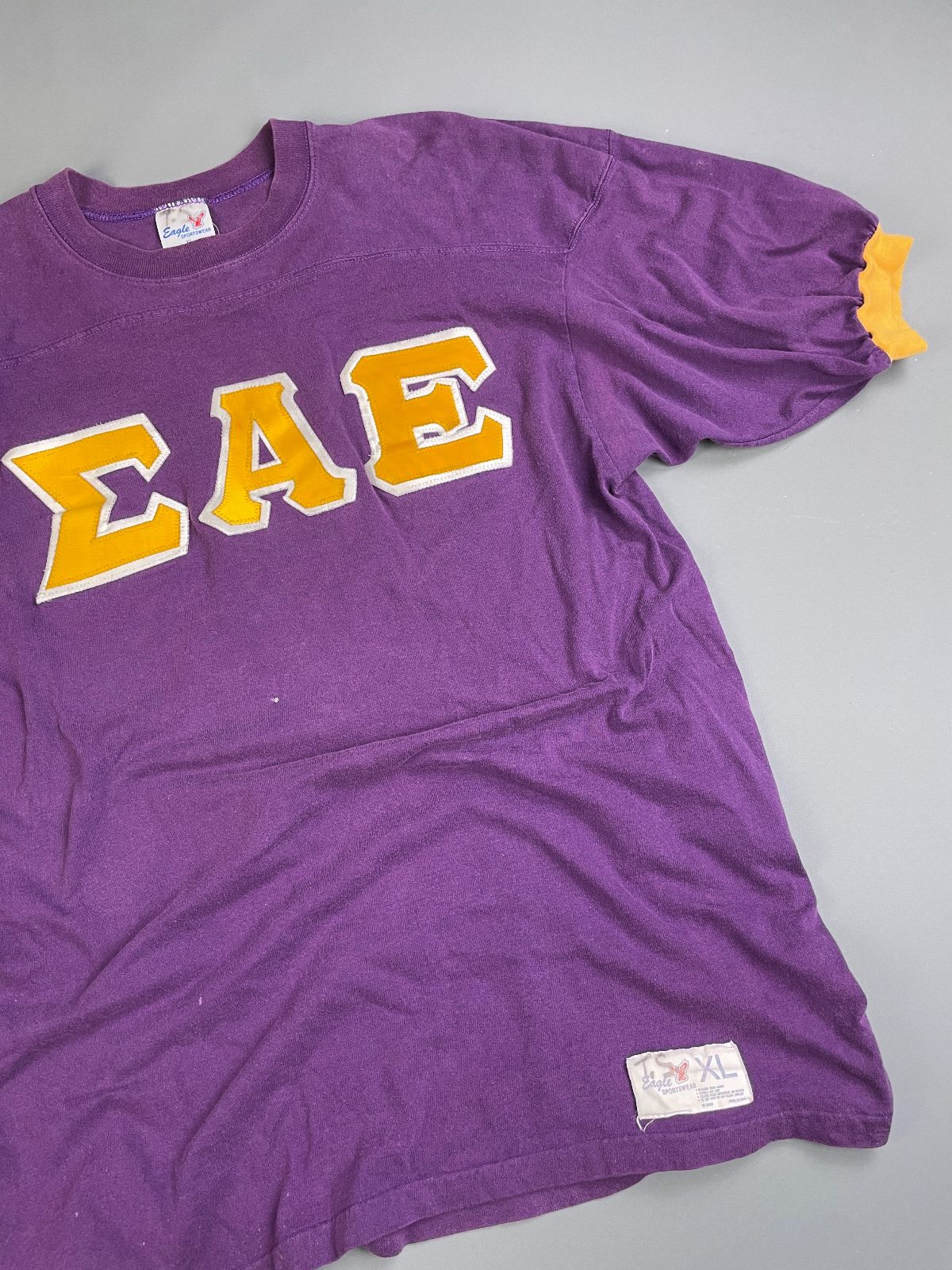 EAGLE SPORTSWEAR *AS-IS* COOL! 1970S-80S FRATERNAL LETTERING 100% COTTON RINGER TSHIRT in PURPLE, YELLOW
