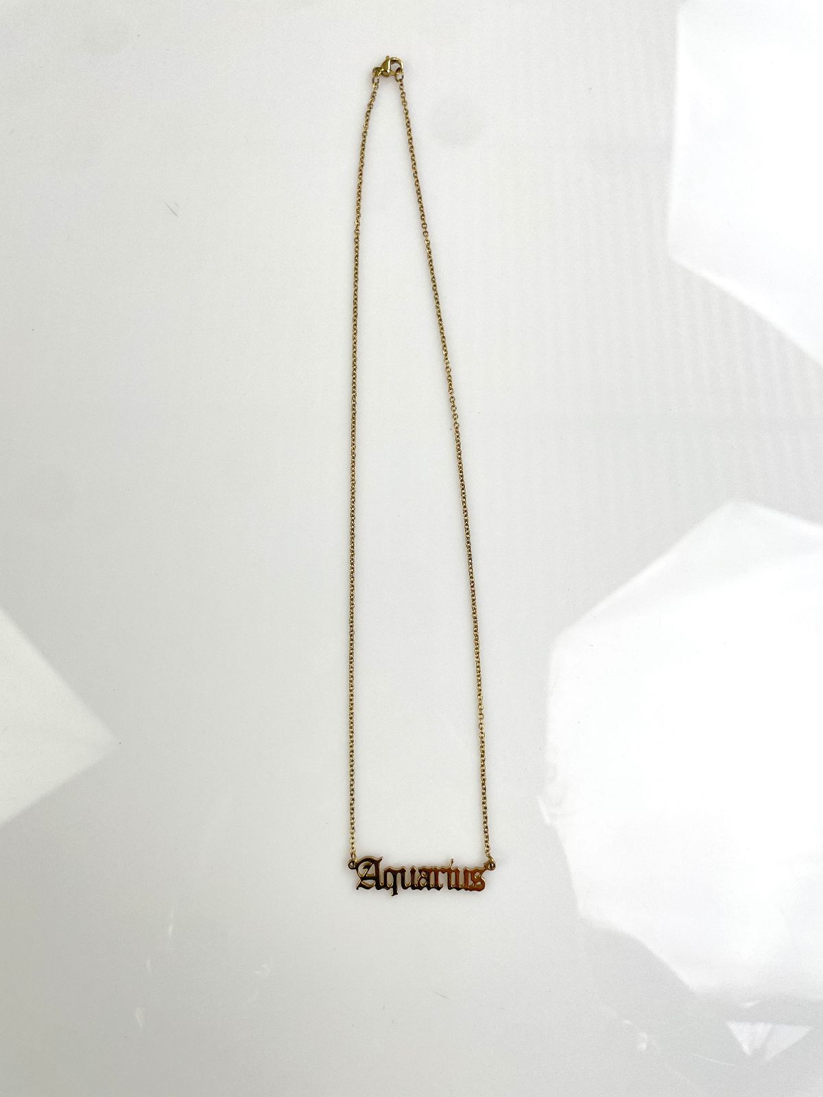 AQUARIUS OLD ENGLISH LETTERING PLAQUE NECKLACE in GOLD