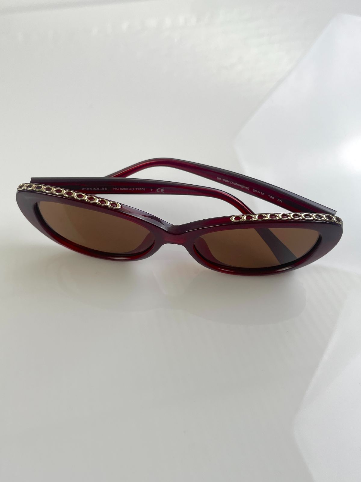 COACH CUSTOM TINT, ROUNDED CAT EYE SUNGLASSES, MONOGRAM C-CHAIN EMBELLISHED TOP BROW - AUBERGINE in MAROON,